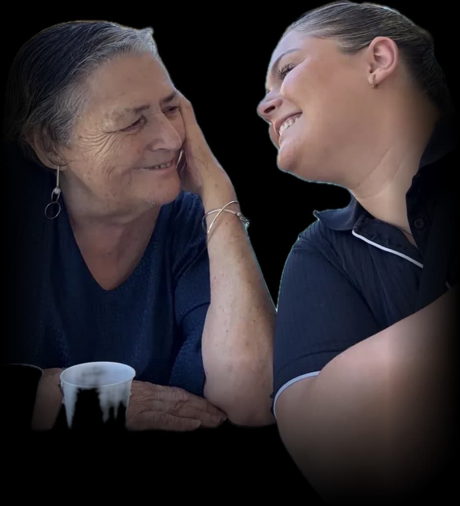 A participant and support worker sharing a cuppa