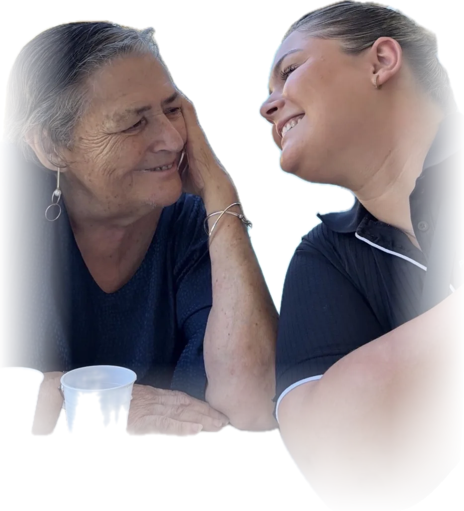 A participant and her Parcare support worker sharing a laugh over a cuppa
